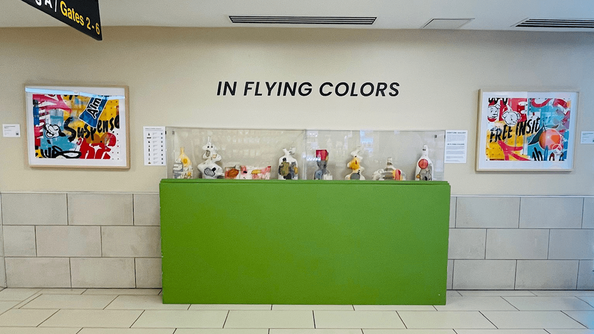 A display of artwork with the words, "In Flying Colors."