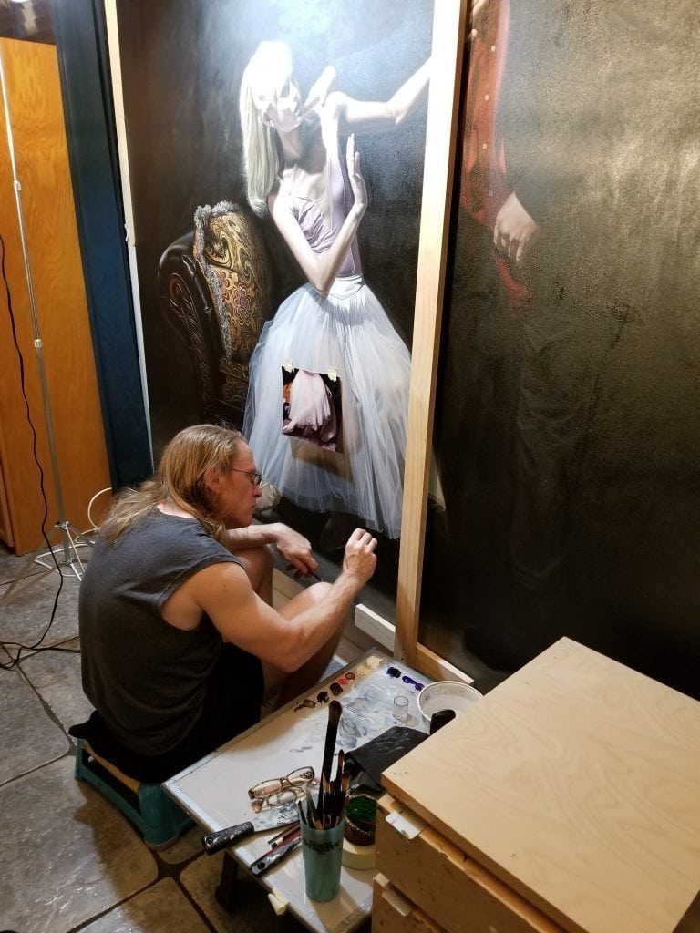 Florida artist Kevin Grass works on his large Not #MeToo: No More Casting Couch painting in his living room. 