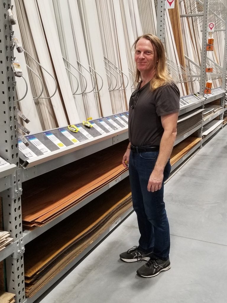 Florida artist Kevin Grass picks out frame molding at Lowe's.