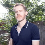 A man poses outdoors.