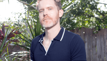 A man poses outdoors.