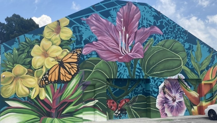 A mural depicts flowers and butterflies.