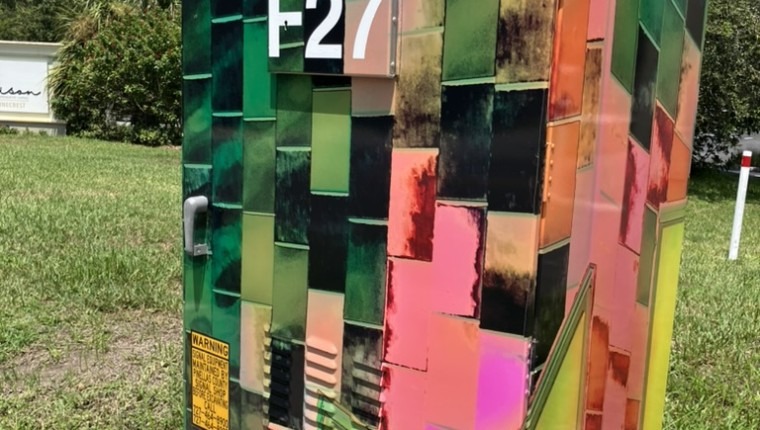 A signal box is decorated with an abstract pattern.