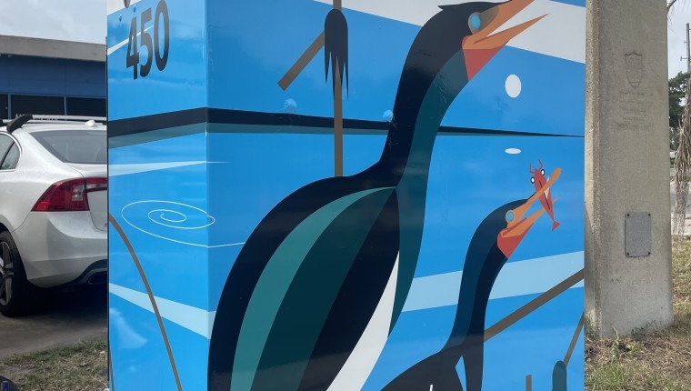 A signal box is decorated with two birds.