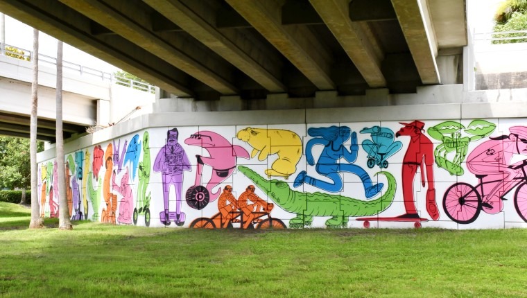 A colorful mural under an overpass.