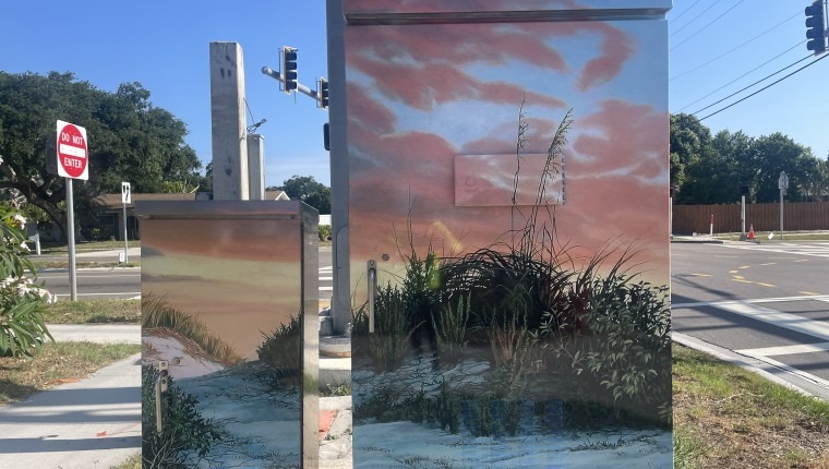 A signal box is decorated with sand dunes and sea oats.