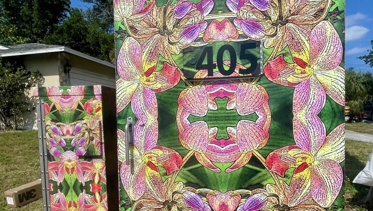 A signal box is decorated with orchids.