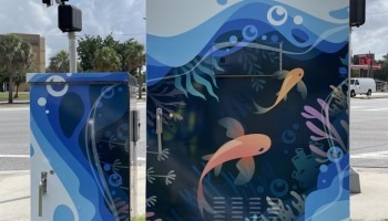 A signal box is decorated with a marine scene.