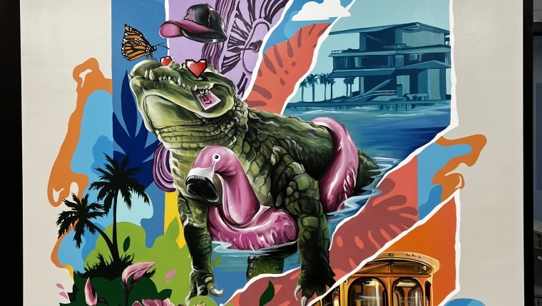 A mural depicts an alligator wearing a flamingo float.