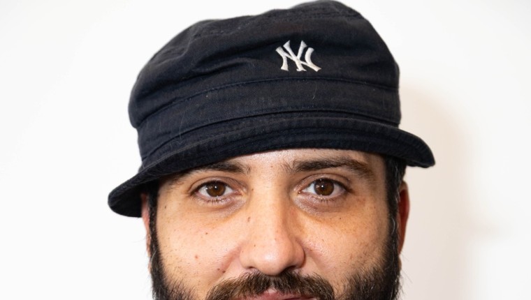 A man wears a bucket hat,