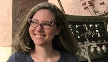 A woman smiles for a photo.