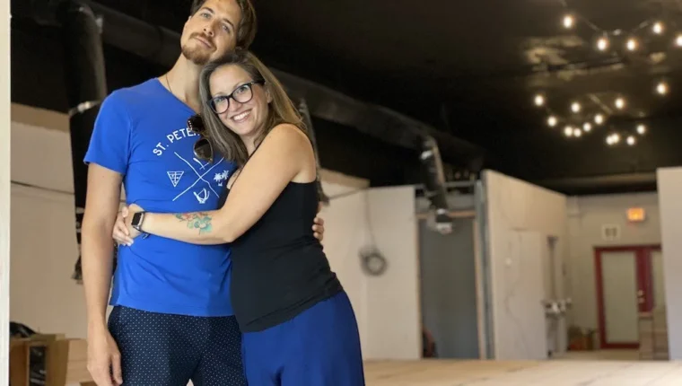 A man and woman embrace.