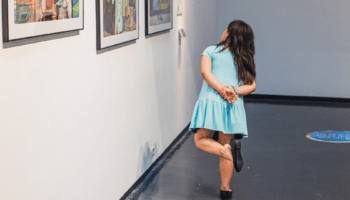 A child looks at artwork.
