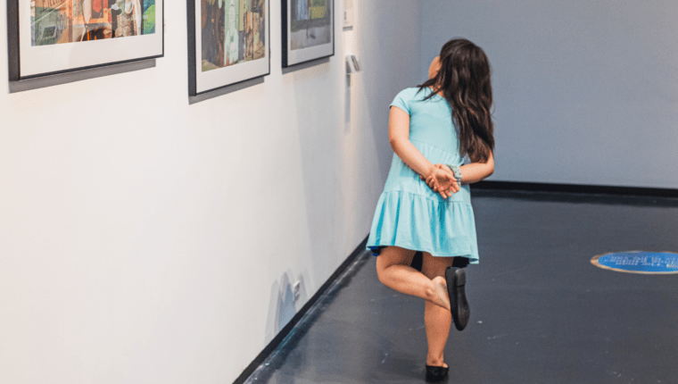 A child looks at artwork.