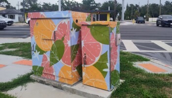 A signal box is decorated with citrus fruit.